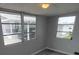 This bedroom has gray laminate flooring and three large windows that let in plenty of natural light at 5112 Glen Echo Ave, Sarasota, FL 34234