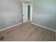 Bright bedroom boasts wood-look flooring and neutral walls with a view into the next room at 5112 Glen Echo Ave, Sarasota, FL 34234