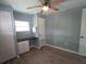 Well-lit bedroom features a ceiling fan, light walls, and desk with drawers at 5112 Glen Echo Ave, Sarasota, FL 34234