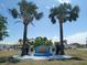 Community sign with fountain surrounded by palm trees; a welcoming view at 5112 Glen Echo Ave, Sarasota, FL 34234