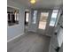 Entryway with a decorative mirror, a glass front door, and gray wood-look floors that flow into other rooms at 5112 Glen Echo Ave, Sarasota, FL 34234