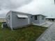 Home's exterior with awnings, situated on a well-maintained property at 5112 Glen Echo Ave, Sarasota, FL 34234