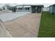 Welcoming home with paved driveway and convenient covered parking, showcasing its curb appeal at 5112 Glen Echo Ave, Sarasota, FL 34234