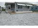 Pavers and patio lead to the front door of this house, framed by light blue siding and storm windows at 5112 Glen Echo Ave, Sarasota, FL 34234