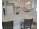Well-lit kitchen featuring white cabinets, modern appliances, and ample counter space, perfect for cooking and entertaining at 5112 Glen Echo Ave, Sarasota, FL 34234