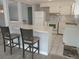 Bright open kitchen featuring white cabinets, modern appliances, and a convenient breakfast bar, creating an inviting atmosphere at 5112 Glen Echo Ave, Sarasota, FL 34234