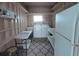 Functional laundry room with washer, dryer, sink, shelves, and ample storage space at 5112 Glen Echo Ave, Sarasota, FL 34234