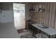 This is the laundry room with appliances, shelving, and access to the outdoors at 5112 Glen Echo Ave, Sarasota, FL 34234