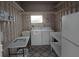 Functional laundry room with washer, dryer, sink, shelves, and ample storage space at 5112 Glen Echo Ave, Sarasota, FL 34234
