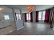 Spacious living area with hardwood floors, chandelier, and large windows, providing plenty of light and a welcoming ambiance at 5112 Glen Echo Ave, Sarasota, FL 34234