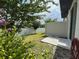 Fenced backyard with green grass, landscaping, and a concrete patio, providing a private outdoor space at 5812 Ocean Isle Dr, Nokomis, FL 34275