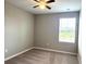 Bedroom with carpet flooring, a ceiling fan, and a window letting in natural light at 5812 Ocean Isle Dr, Nokomis, FL 34275