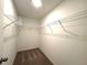 Walk-in closet with carpet flooring, wire shelving, and ample storage space for organization at 5812 Ocean Isle Dr, Nokomis, FL 34275
