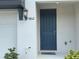 Close up of the front entrance with a blue door and house number at 5812 Ocean Isle Dr, Nokomis, FL 34275