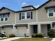 Charming townhome featuring neutral siding, blue shutters, and well-manicured front lawn at 5812 Ocean Isle Dr, Nokomis, FL 34275