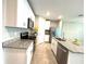 Well-lit kitchen featuring granite counters, stainless steel appliances, and white cabinets at 5812 Ocean Isle Dr, Nokomis, FL 34275