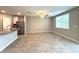Open-concept living area featuring tile floors, a ceiling fan, and a view of the kitchen with stainless steel appliances at 5812 Ocean Isle Dr, Nokomis, FL 34275