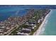 Stunning aerial view of a beachfront community with beautiful homes, condos, and golf course along the shoreline at 585 Gunwale Ln, Longboat Key, FL 34228