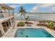 Aerial perspective of the property, featuring a pool, jacuzzi, outdoor area, and stunning waterfront scenery at 585 Gunwale Ln, Longboat Key, FL 34228