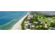 Beautiful aerial view of beachfront condos nestled along a golf course and pristine sandy beach at 585 Gunwale Ln, Longboat Key, FL 34228