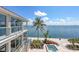 Waterfront property showcasing a pool, patio area, meticulously manicured landscaping, and ocean views at 585 Gunwale Ln, Longboat Key, FL 34228