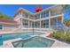 Luxurious home featuring a pool, spa, and balconies overlooking the waterfront at 585 Gunwale Ln, Longboat Key, FL 34228