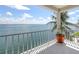 Balcony view featuring metal railing, tile floors, potted palm and views of clear, turquoise waters at 585 Gunwale Ln, Longboat Key, FL 34228