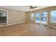 Bright bedroom featuring wood floors and scenic views of the pool and waterfront at 585 Gunwale Ln, Longboat Key, FL 34228