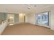 Open bonus room with tile entry, access to a balcony, and neutral carpeting, ideal for entertaining or relaxing at 585 Gunwale Ln, Longboat Key, FL 34228