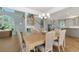 Dining area with staircase and open view to the kitchen, hardwood floors and chandelier lighting at 585 Gunwale Ln, Longboat Key, FL 34228