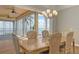 Waterfront dining area with walls of windows offering scenic views and a stylish chandelier for ambiance at 585 Gunwale Ln, Longboat Key, FL 34228