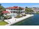 The exterior of this waterfront property features lush landscaping, a private pool, and stunning water views at 585 Gunwale Ln, Longboat Key, FL 34228