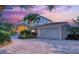 Beautiful home exterior with a paved driveway, well-maintained landscaping, and a spacious two-car garage at 585 Gunwale Ln, Longboat Key, FL 34228