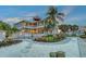 Expansive two-story home featuring lush landscaping, a tower, and a waterfront view for luxurious outdoor living at 585 Gunwale Ln, Longboat Key, FL 34228