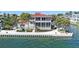 Waterfront home with lush landscaping, pool and spa overlooking the water at 585 Gunwale Ln, Longboat Key, FL 34228