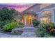 Elegant front entrance with stone steps, arched entryway, and lush landscaping creating a welcoming curb appeal at 585 Gunwale Ln, Longboat Key, FL 34228