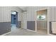 Hallway with striped wallpaper, closet and doorways leading to the bathroom and bedroom at 585 Gunwale Ln, Longboat Key, FL 34228