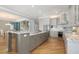 Gourmet kitchen with granite countertops, stainless steel appliances, and views into the dining and living spaces at 585 Gunwale Ln, Longboat Key, FL 34228