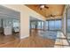 Open concept living room leading to kitchen and sun room with water views at 585 Gunwale Ln, Longboat Key, FL 34228