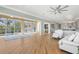 Open concept living space with a hardwood floor, open to the kitchen and screened porch at 585 Gunwale Ln, Longboat Key, FL 34228