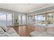 Bright living room featuring hardwood floors and expansive sliding glass doors with ocean views at 585 Gunwale Ln, Longboat Key, FL 34228