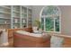 Cozy living room with built-in shelving, comfortable seating, and a large window offering serene outdoor views at 585 Gunwale Ln, Longboat Key, FL 34228