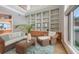 Spacious living room showcasing built-in shelves, comfortable seating, and large windows for ample natural light at 585 Gunwale Ln, Longboat Key, FL 34228
