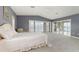 Serene main bedroom featuring water views, access to a balcony, and a calming, inviting atmosphere at 585 Gunwale Ln, Longboat Key, FL 34228
