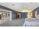 Main bedroom with grey carpet, ceiling fan, and access to the balcony with expansive outdoor views at 585 Gunwale Ln, Longboat Key, FL 34228
