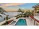 Aerial view of a pool and garden featuring lush landscaping and beautiful waterfront views at 585 Gunwale Ln, Longboat Key, FL 34228