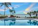 Stunning pool with waterfront views, beautiful landscaping and palm trees at 585 Gunwale Ln, Longboat Key, FL 34228