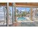 View of a swimming pool and ocean waters from the screened in porch at 585 Gunwale Ln, Longboat Key, FL 34228