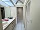 Bathroom featuring tile flooring, a mirror, and a closet at 6505 Stone River Rd # 309, Bradenton, FL 34203