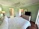 Bright bedroom featuring a ceiling fan, wood floors, and access to a patio at 6505 Stone River Rd # 309, Bradenton, FL 34203